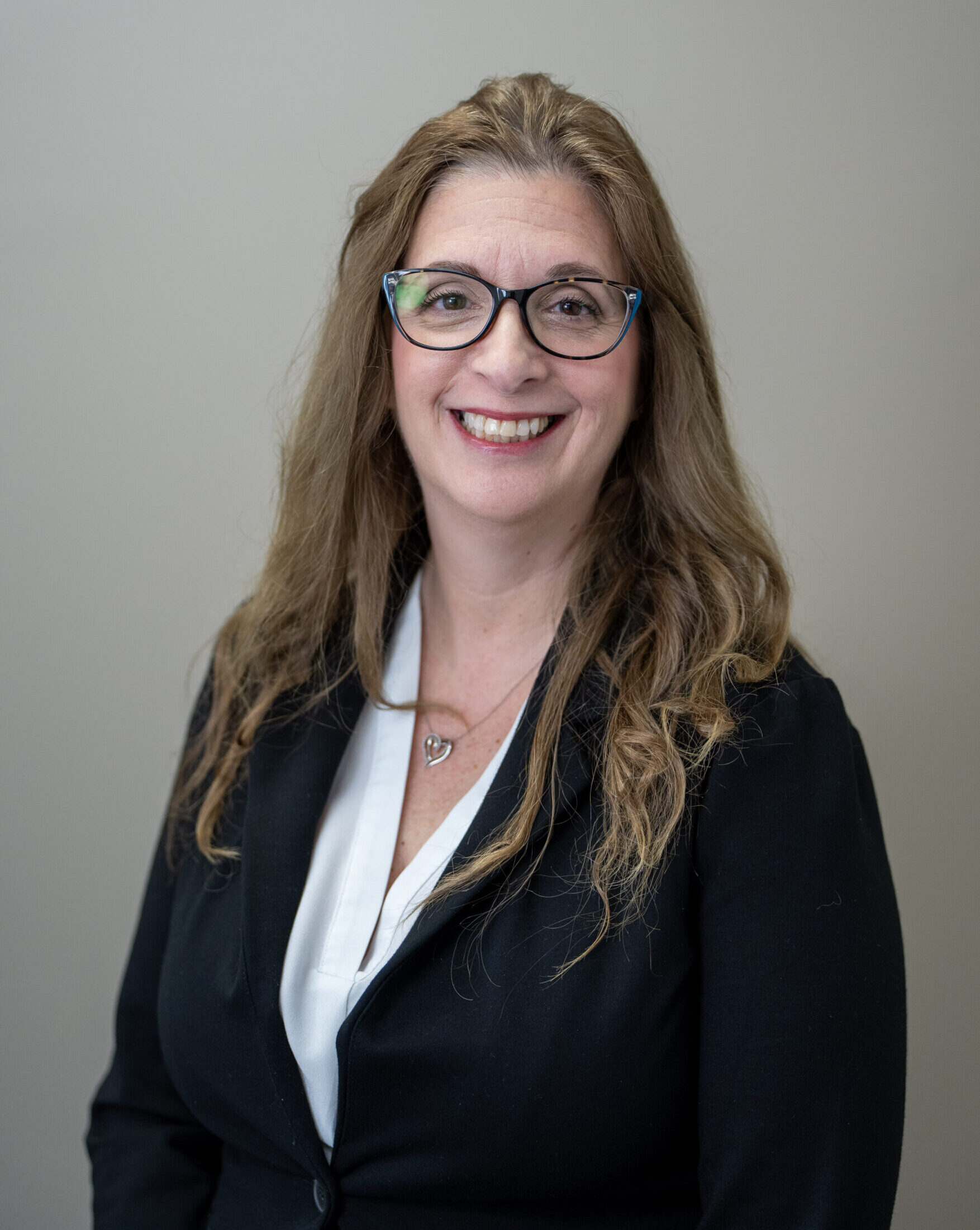 Portrait of a professional personal injury lawyer, smiling in a suit, representing legal expertise.